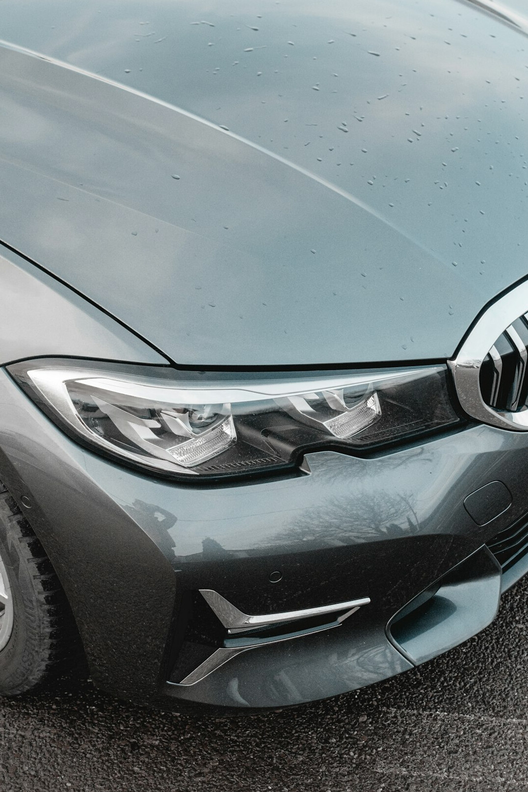 Front of a grey car showing the plastic bumper