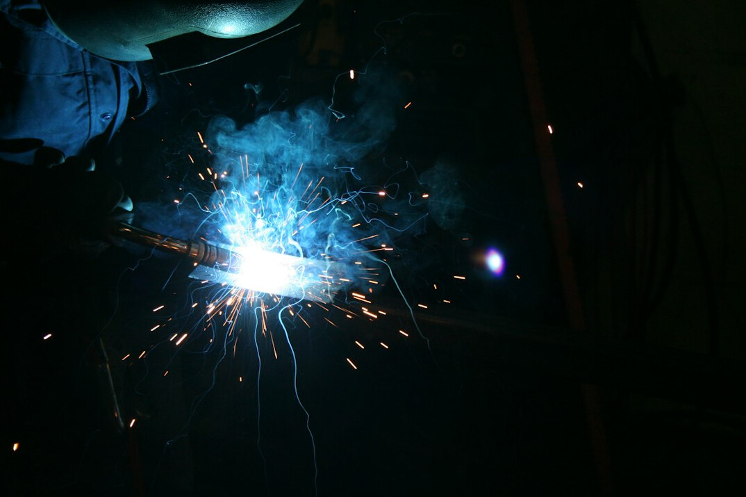 Close-up of plastic welding with a hot air tool and sparks of heat
