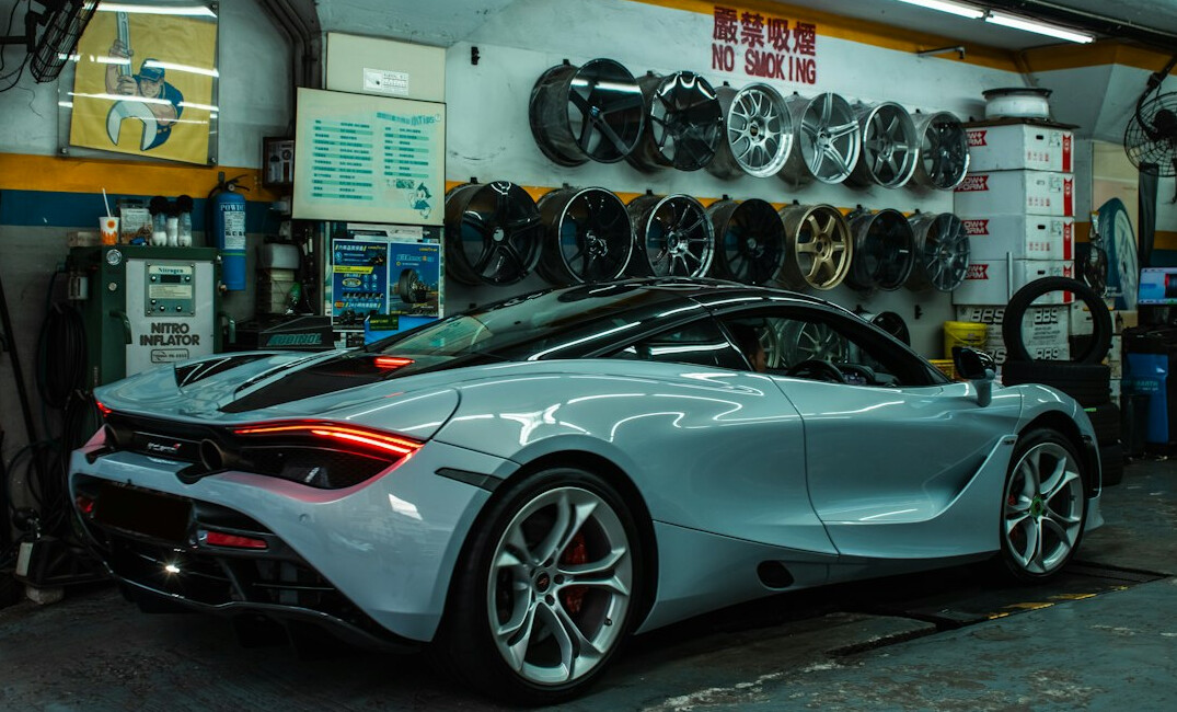 Repaired car being checked in a clean workshop